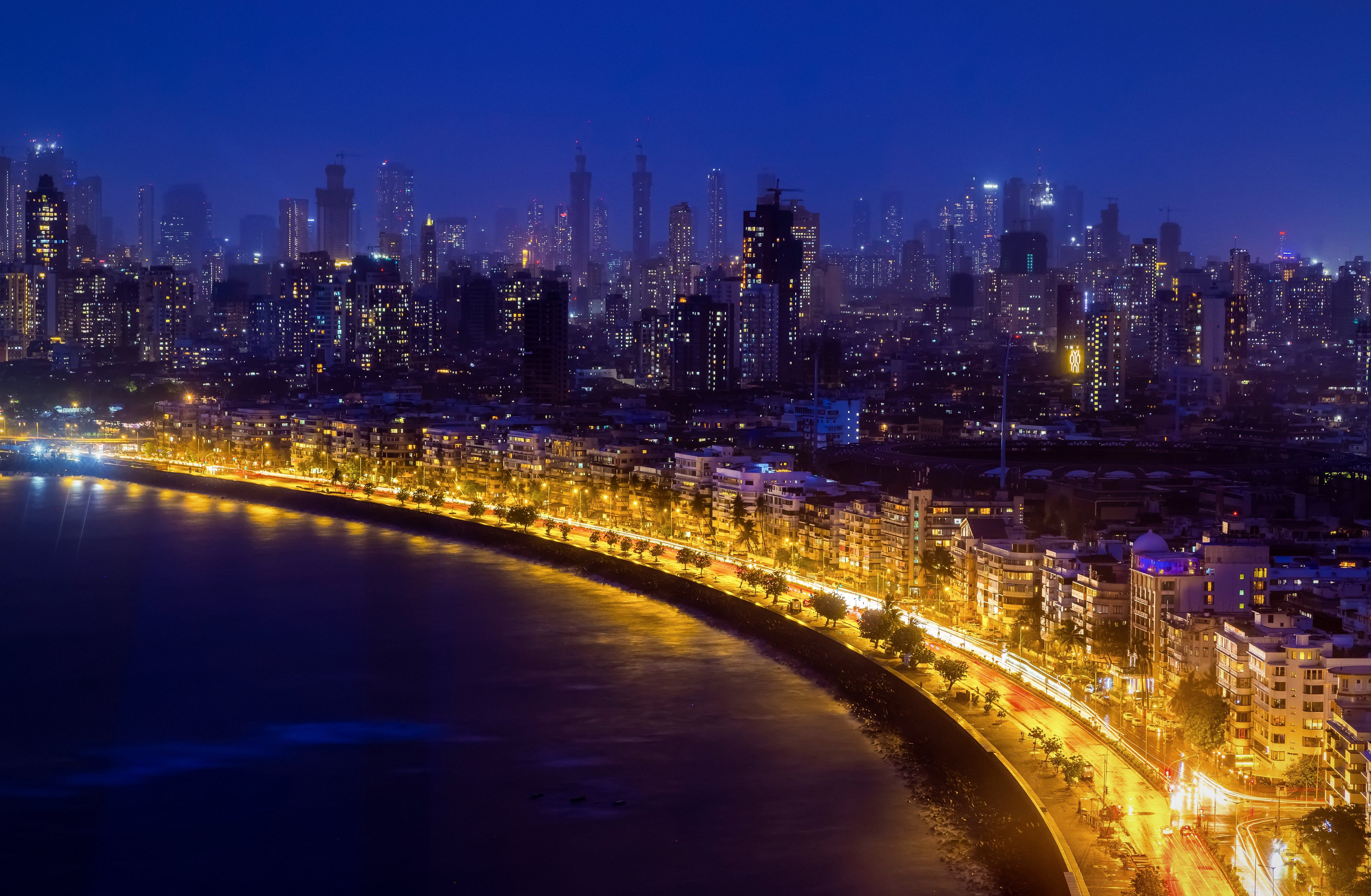 Marine Drive in Mumbai at blue hour, the Queen's Necklace curving below the skyline