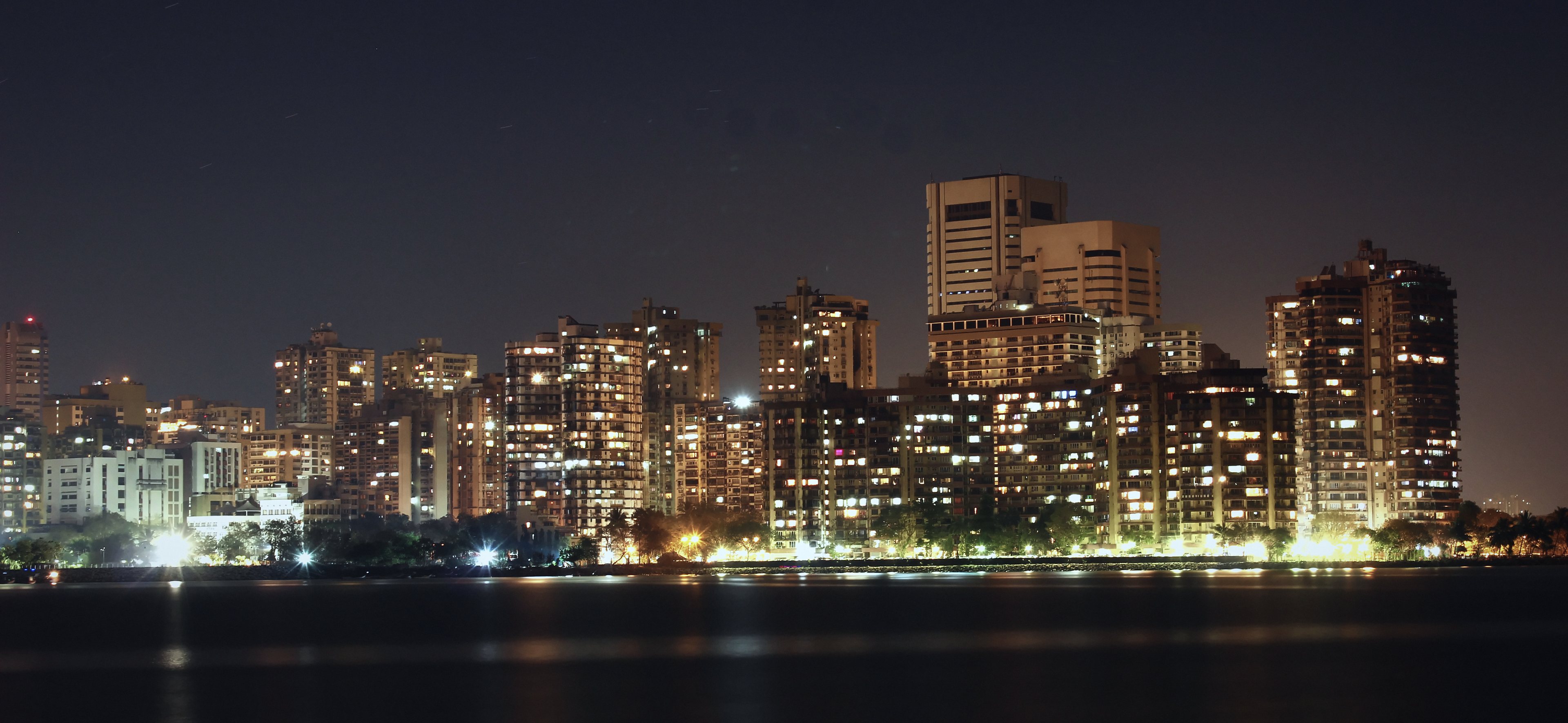 The Nariman Point and Cuffe Parade skyline at night across the bay, office and residential towers lit