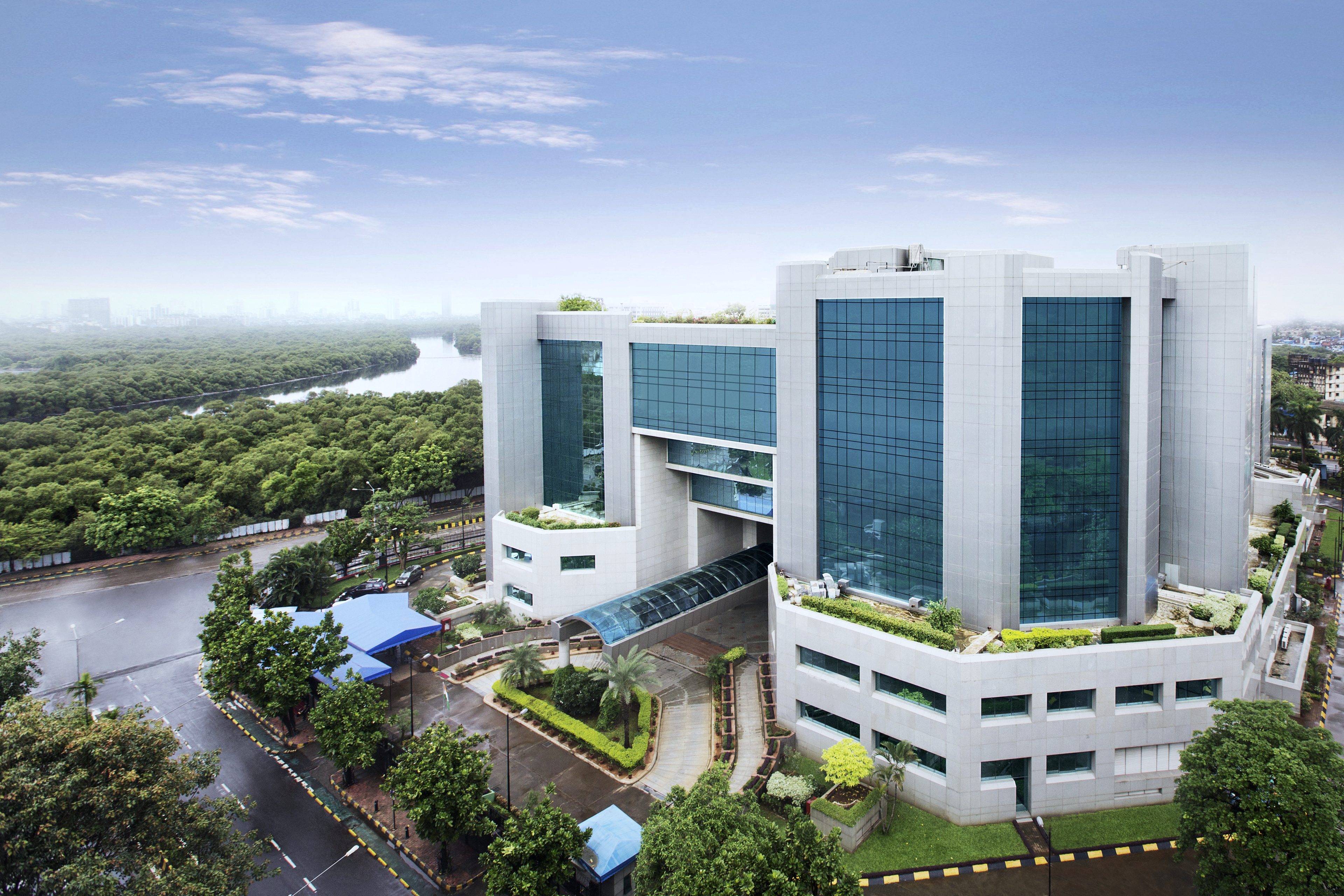 Exchange Plaza in Bandra Kurla Complex, Mumbai, seen from above, glass towers beside the mangroves of the Mithi river
